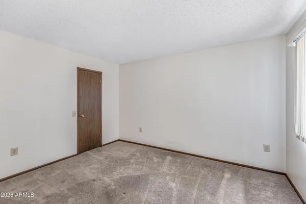 a view of a hallway with closet and wooden floor