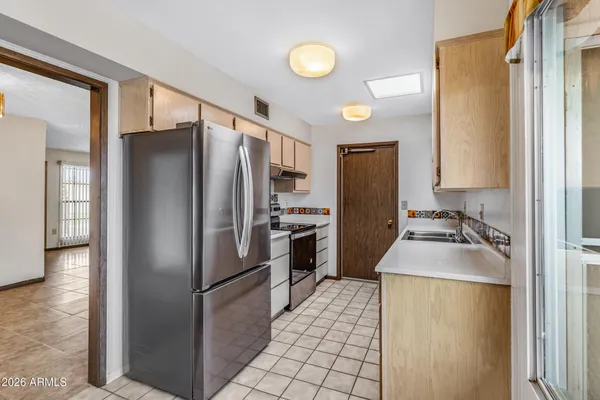 a kitchen with a sink and a refrigerator