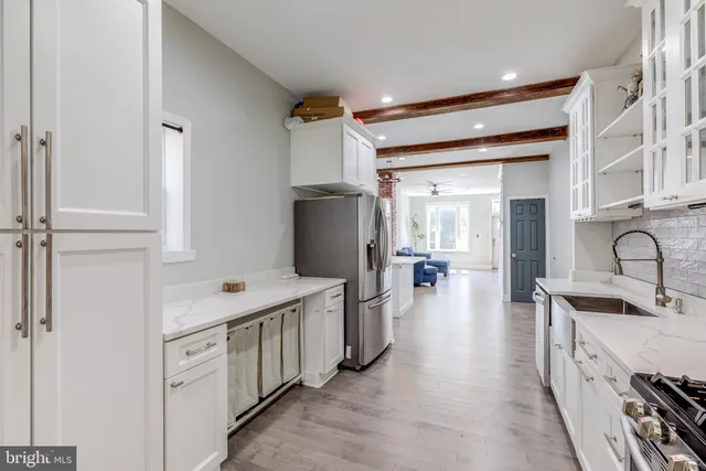 a hallway with cabinets a washer and dryer