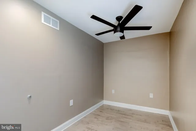 an empty room with windows and closet