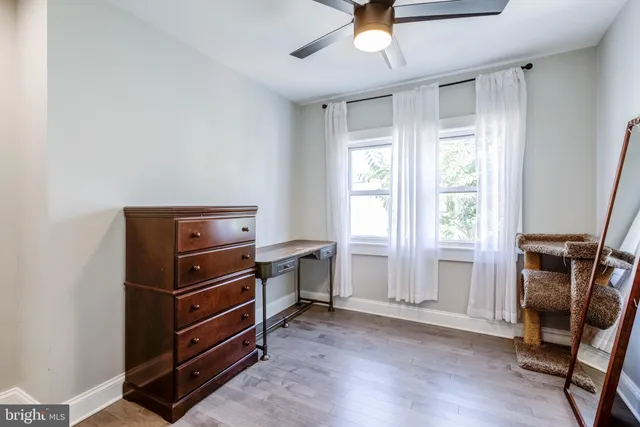 a view of room with furniture and wooden floor