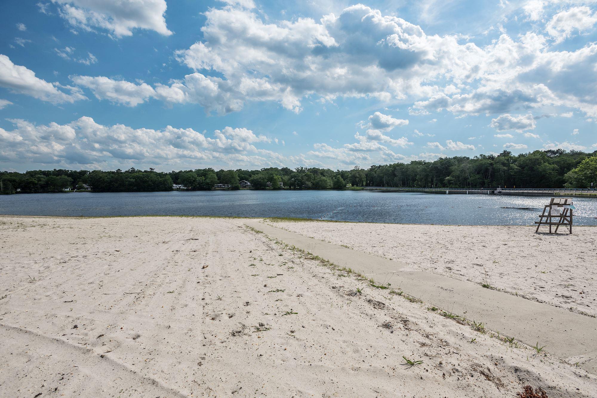 603 New Jersey Road Browns Mills, NJ 08015 - Photo 28 of 28 Serene lakeside retreat with sandy shore.