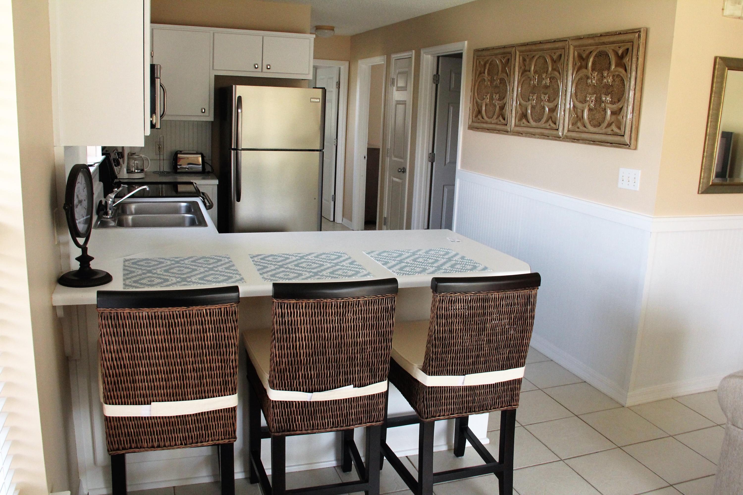 82 Sugar Sand Lane, Unit B4 Santa Rosa Beach, FL 32459 - Photo 16 of 33 a kitchen with a table and chairs