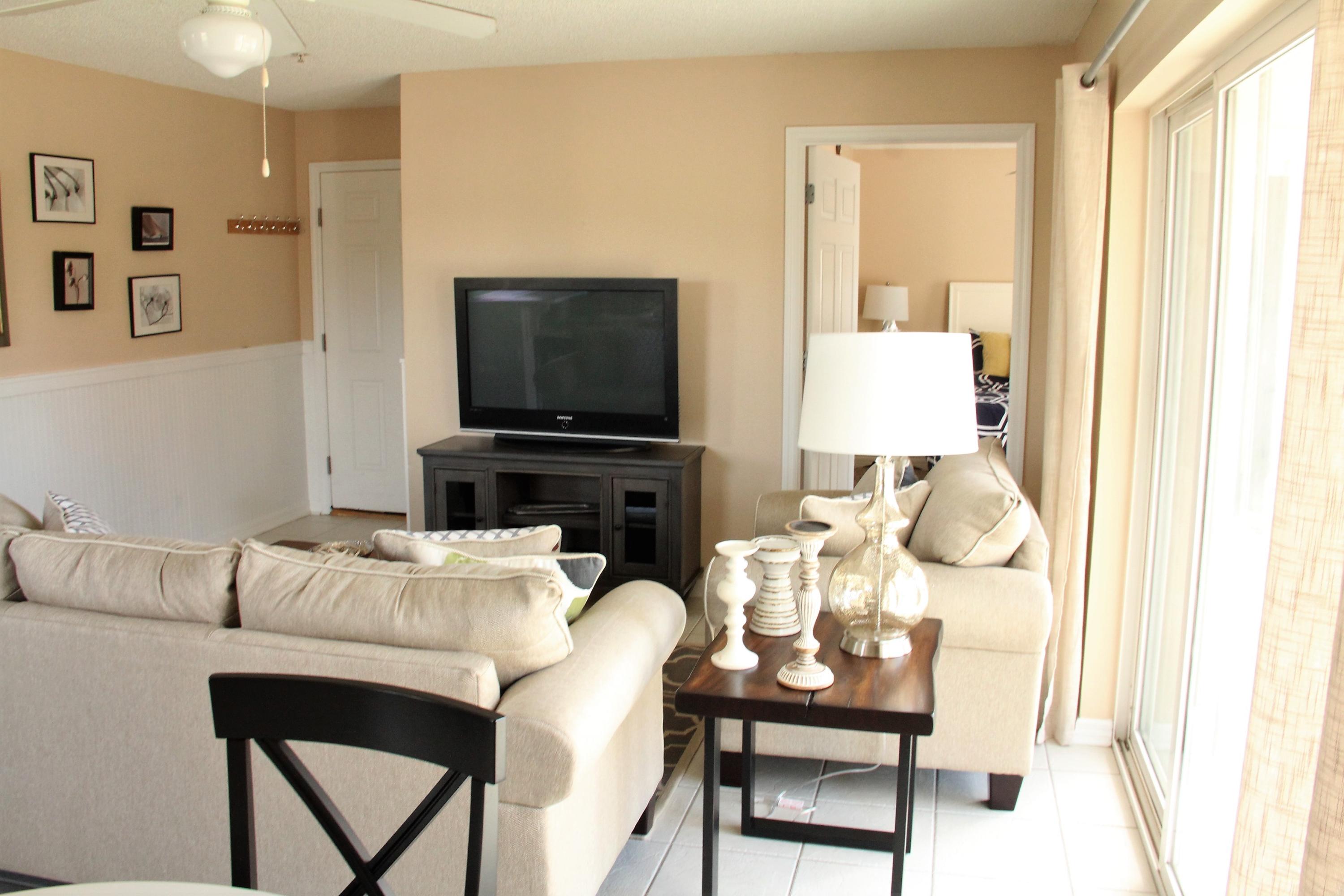 82 Sugar Sand Lane, Unit B4 Santa Rosa Beach, FL 32459 - Photo 3 of 33 a living room with furniture a flat screen tv and a window