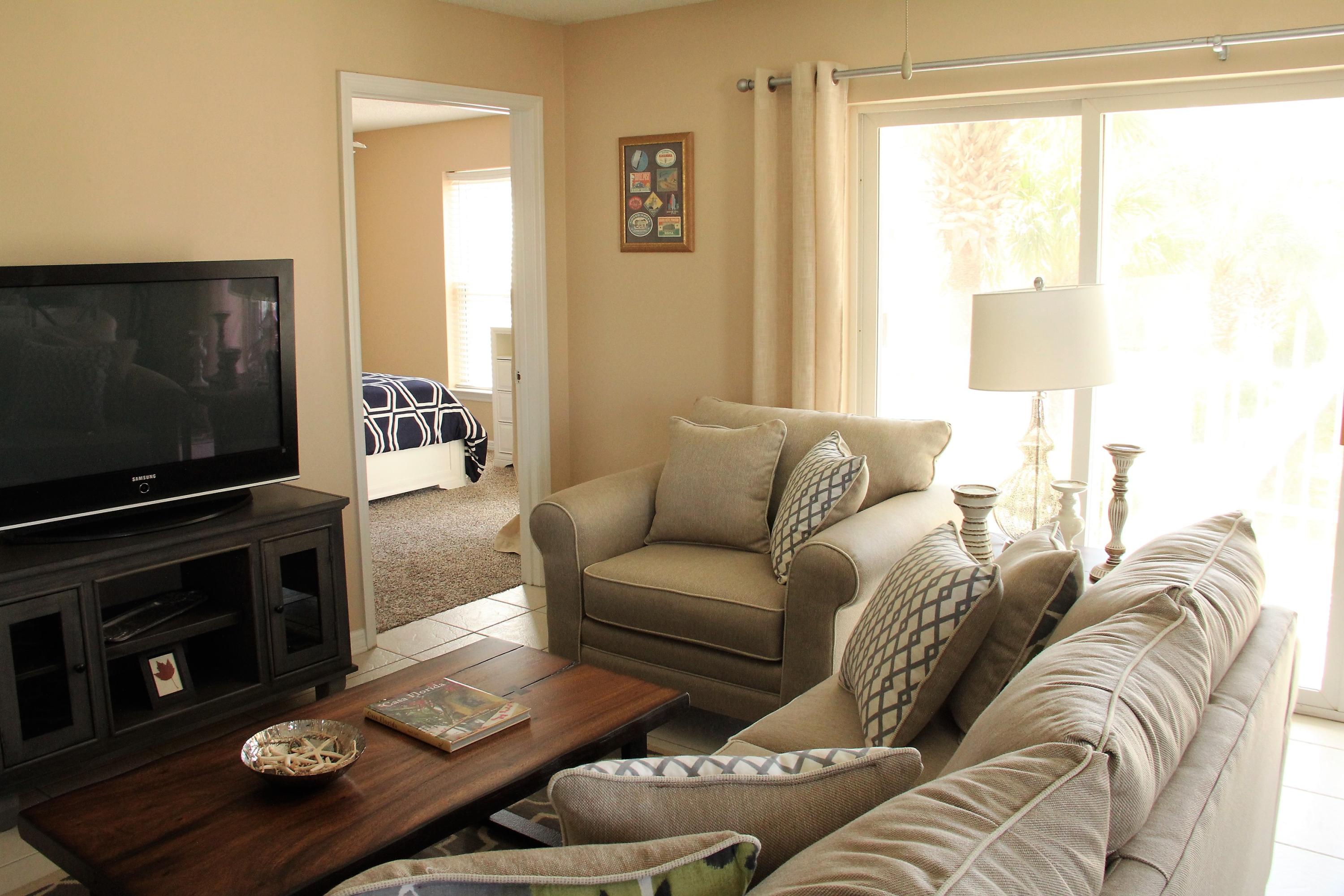 82 Sugar Sand Lane, Unit B4 Santa Rosa Beach, FL 32459 - Photo 5 of 33 a living room with furniture a flat screen tv and a window