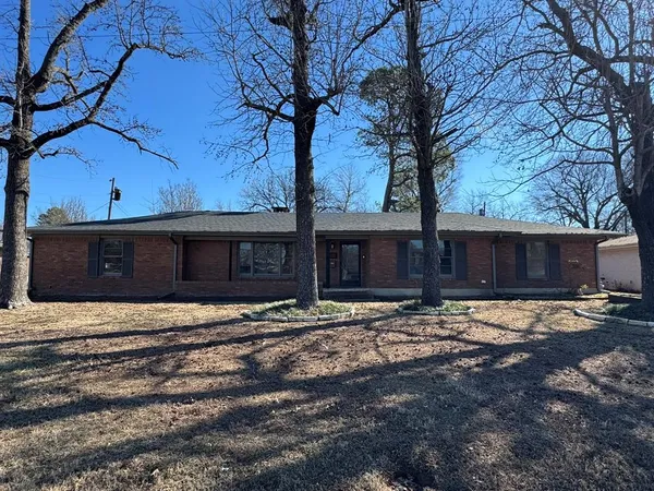 a wooden house with trees in front of it