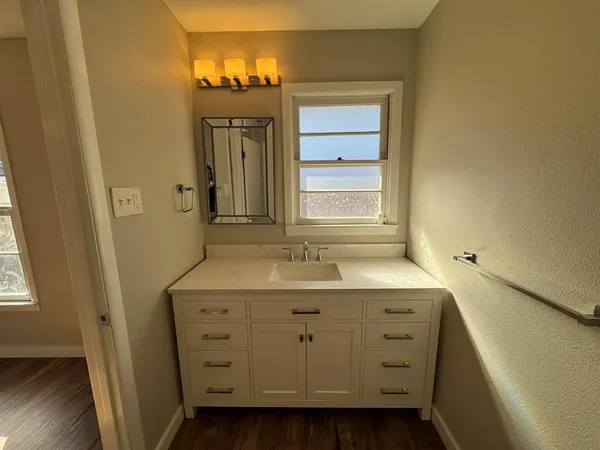 a view of a bathroom with a sink and a mirror
