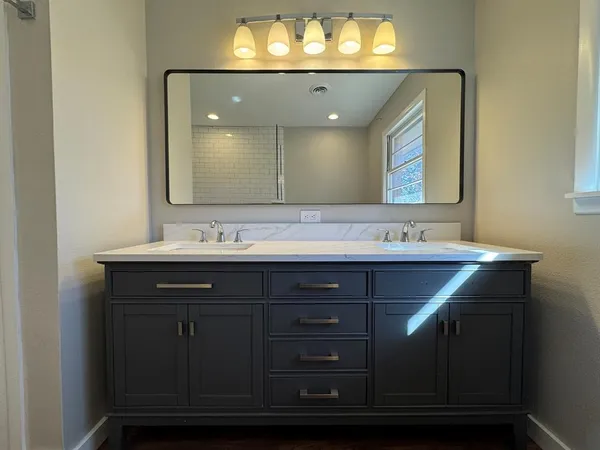 a bathroom with a sink vanity and a mirror