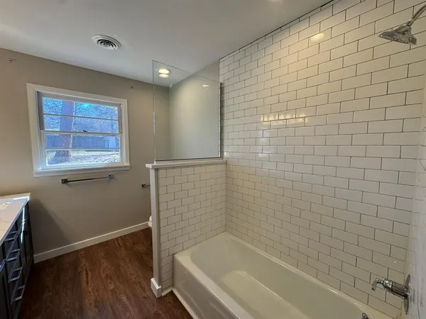 a bathroom with a bathtub and shower