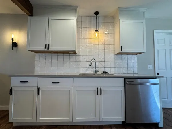 a kitchen with cabinets and appliances