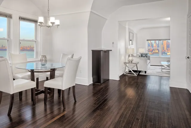 a view of a dining room with furniture and wooden floor