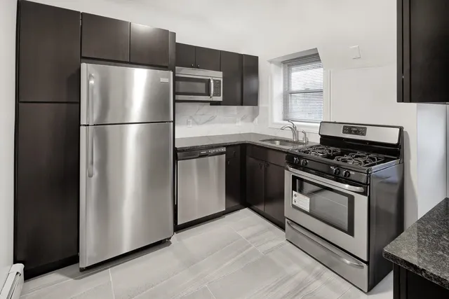 a kitchen with cabinets and stainless steel appliances