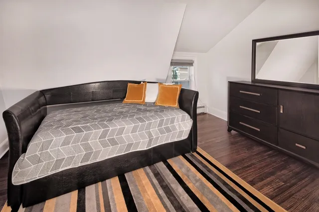 a bedroom with a bed and a dresser