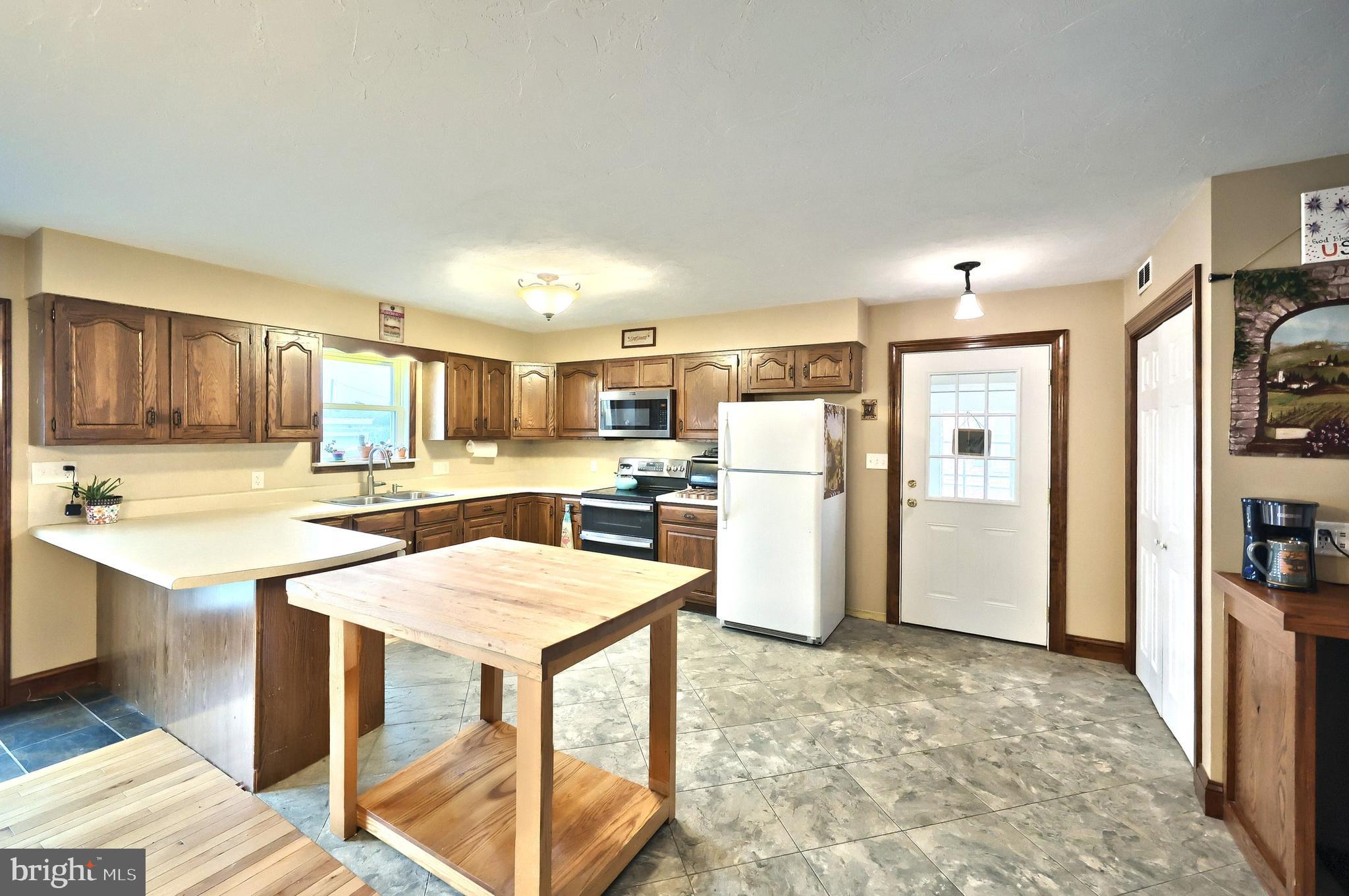 2856 Centennial Road Hanover, PA 17331 - Photo 10 of 34 a kitchen with stainless steel appliances kitchen island granite countertop a refrigerator and a stove top oven