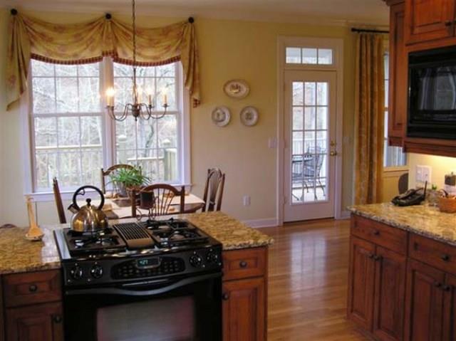 7465 South Harpeth Road Franklin, TN 37064 - Photo 3 of 30 a table with a stove and a potted plant