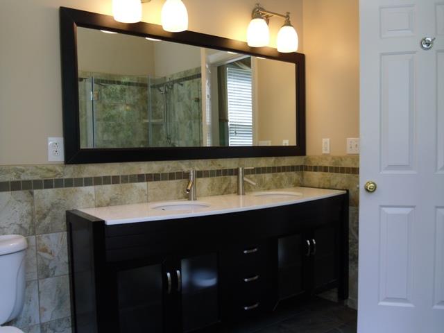 7465 South Harpeth Road Franklin, TN 37064 - Photo 9 of 30 a bathroom with a double vanity sink and a mirror