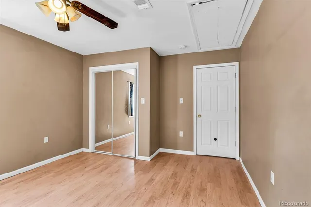 a view of an empty room with wooden floor