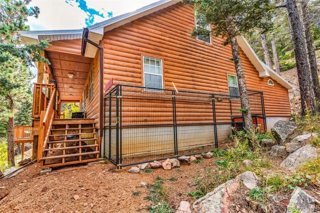 a view of a house with a door and wooden fence