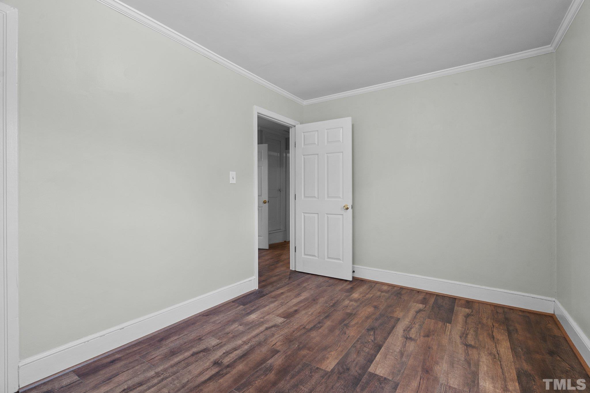 203 Spring Street Louisburg, NC 27549 - Photo 12 of 23 a view of an empty room with wooden floor