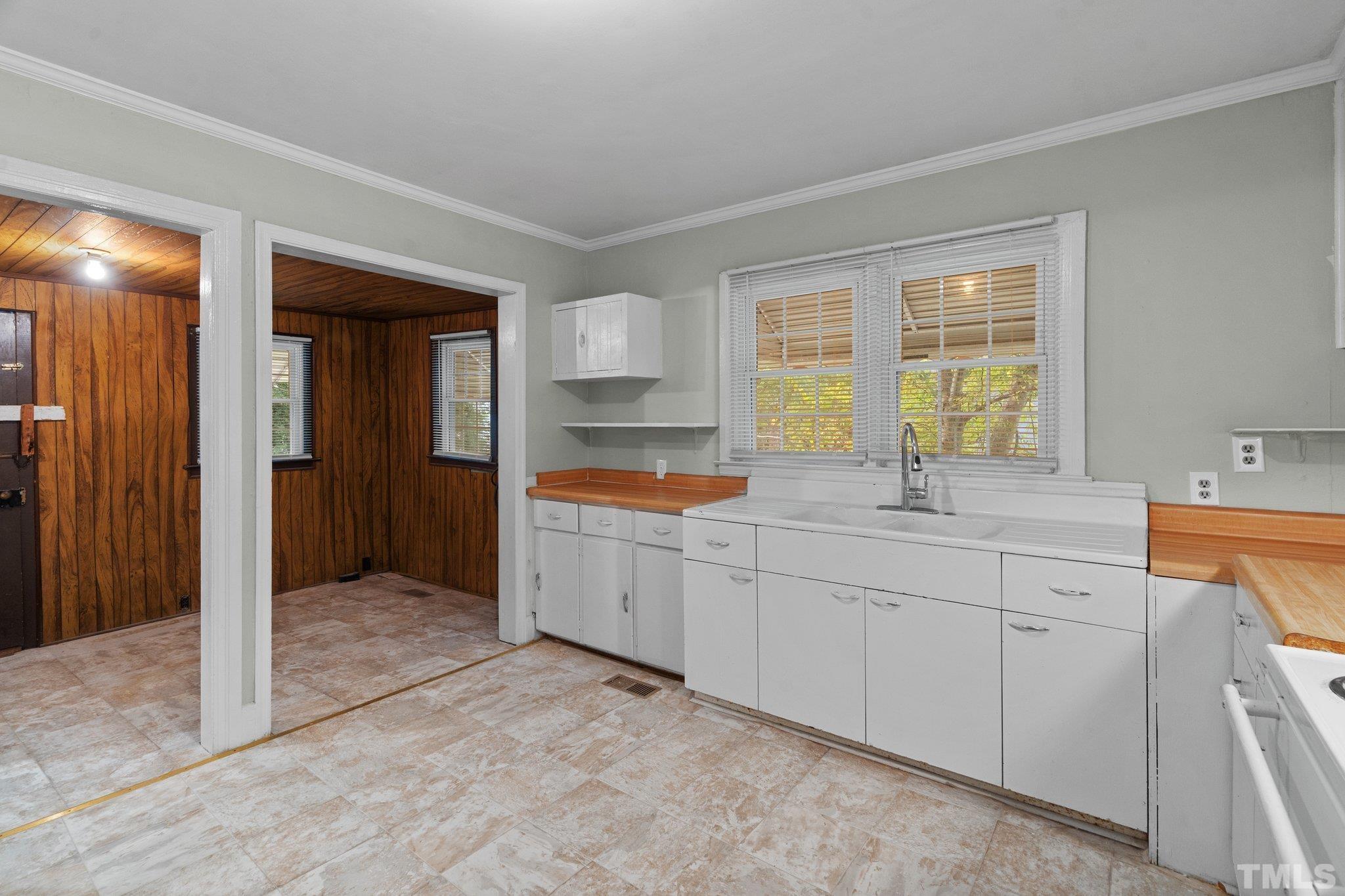 203 Spring Street Louisburg, NC 27549 - Photo 14 of 23 a kitchen with sink and cabinets
