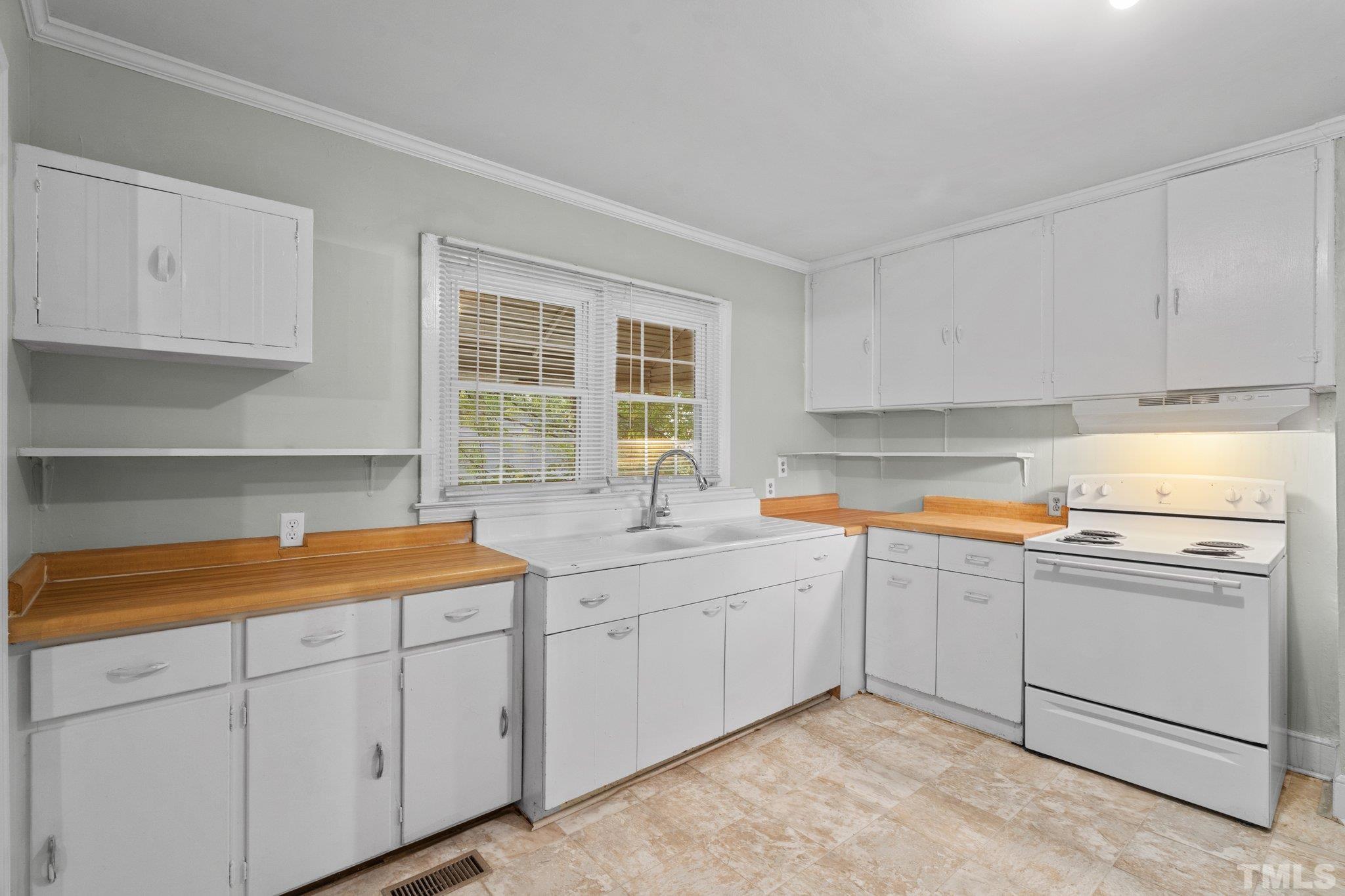 203 Spring Street Louisburg, NC 27549 - Photo 15 of 23 a kitchen with sink cabinets and window