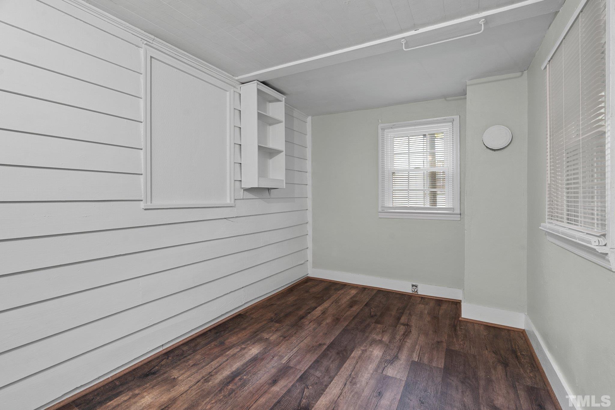 203 Spring Street Louisburg, NC 27549 - Photo 19 of 23 a view of empty room with wooden floor and fan