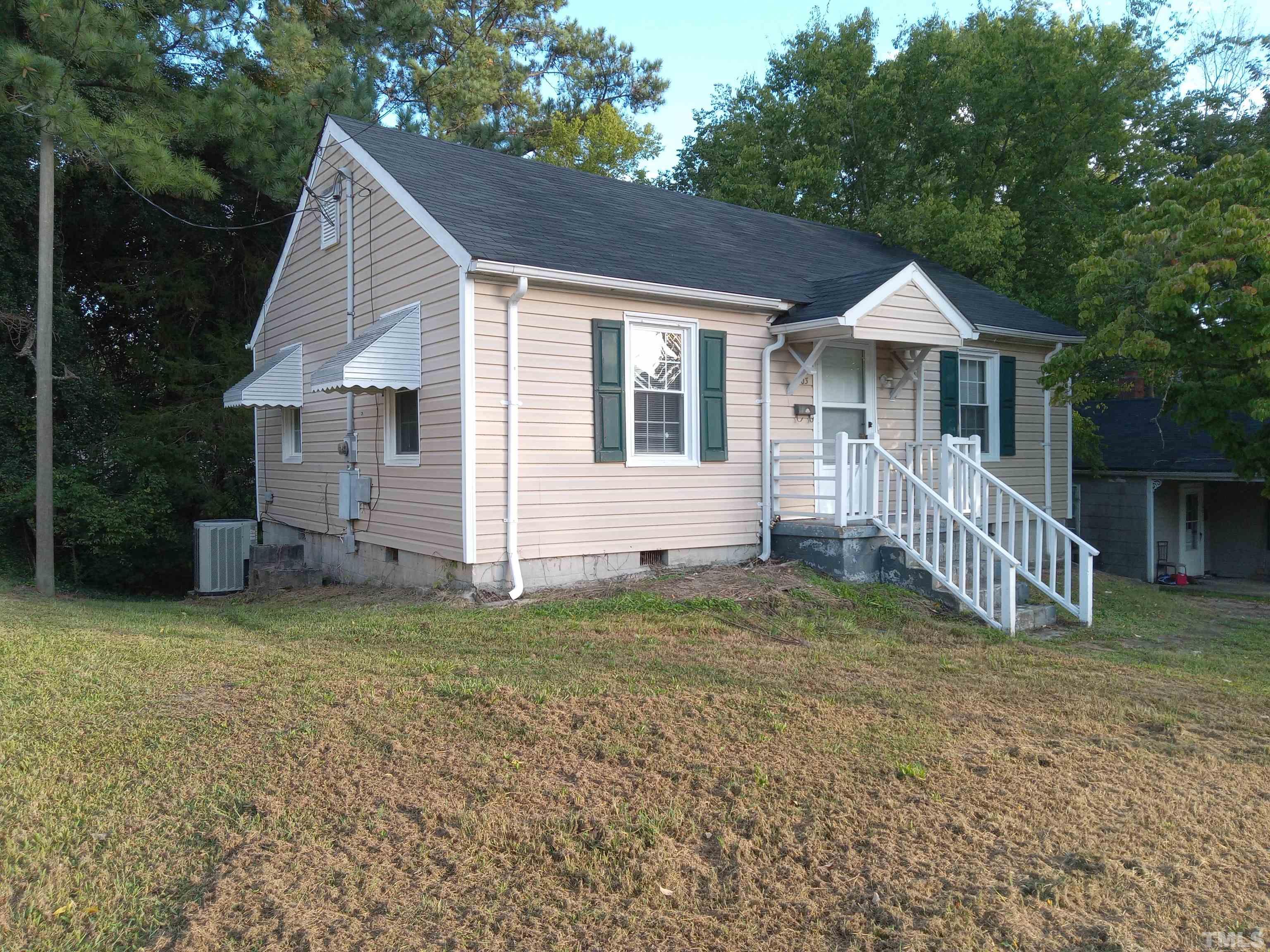203 Spring Street Louisburg, NC 27549 - Photo 2 of 23 a view of a house with a yard and deck