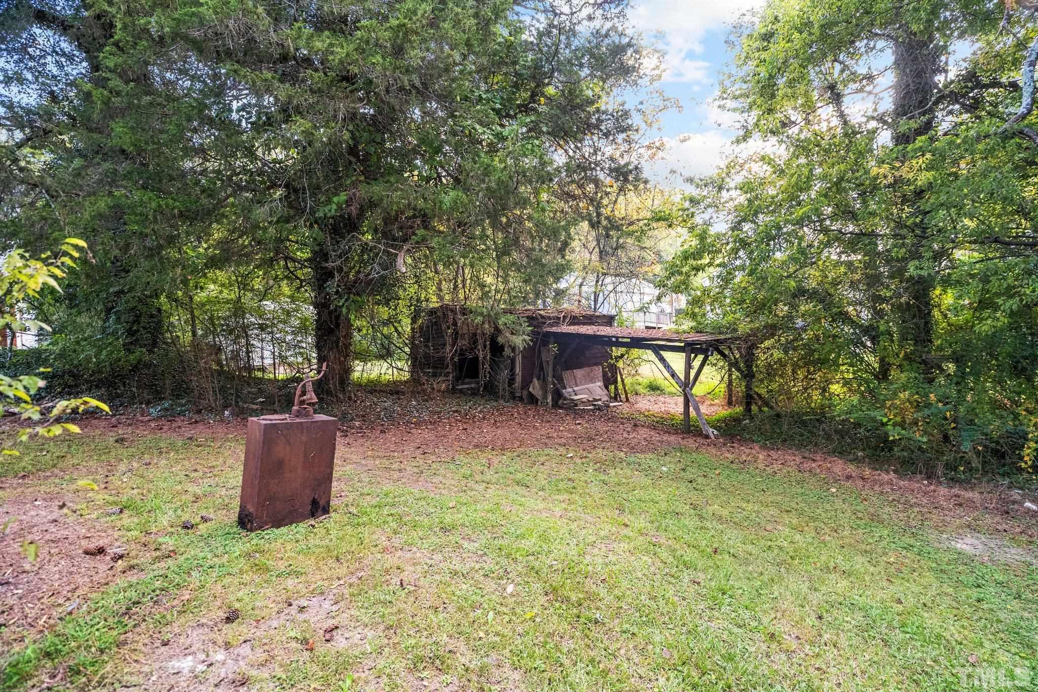 203 Spring Street Louisburg, NC 27549 - Photo 6 of 23 a backyard of a house with fire pit and outdoor seating