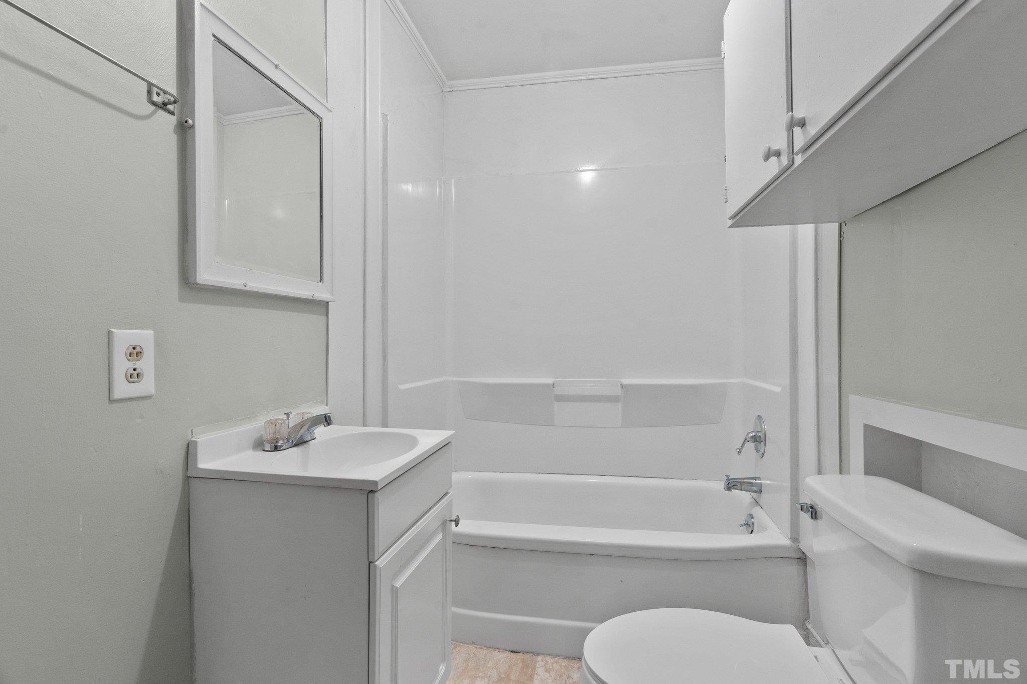 203 Spring Street Louisburg, NC 27549 - Photo 7 of 23 a bathroom with a sink toilet and shower