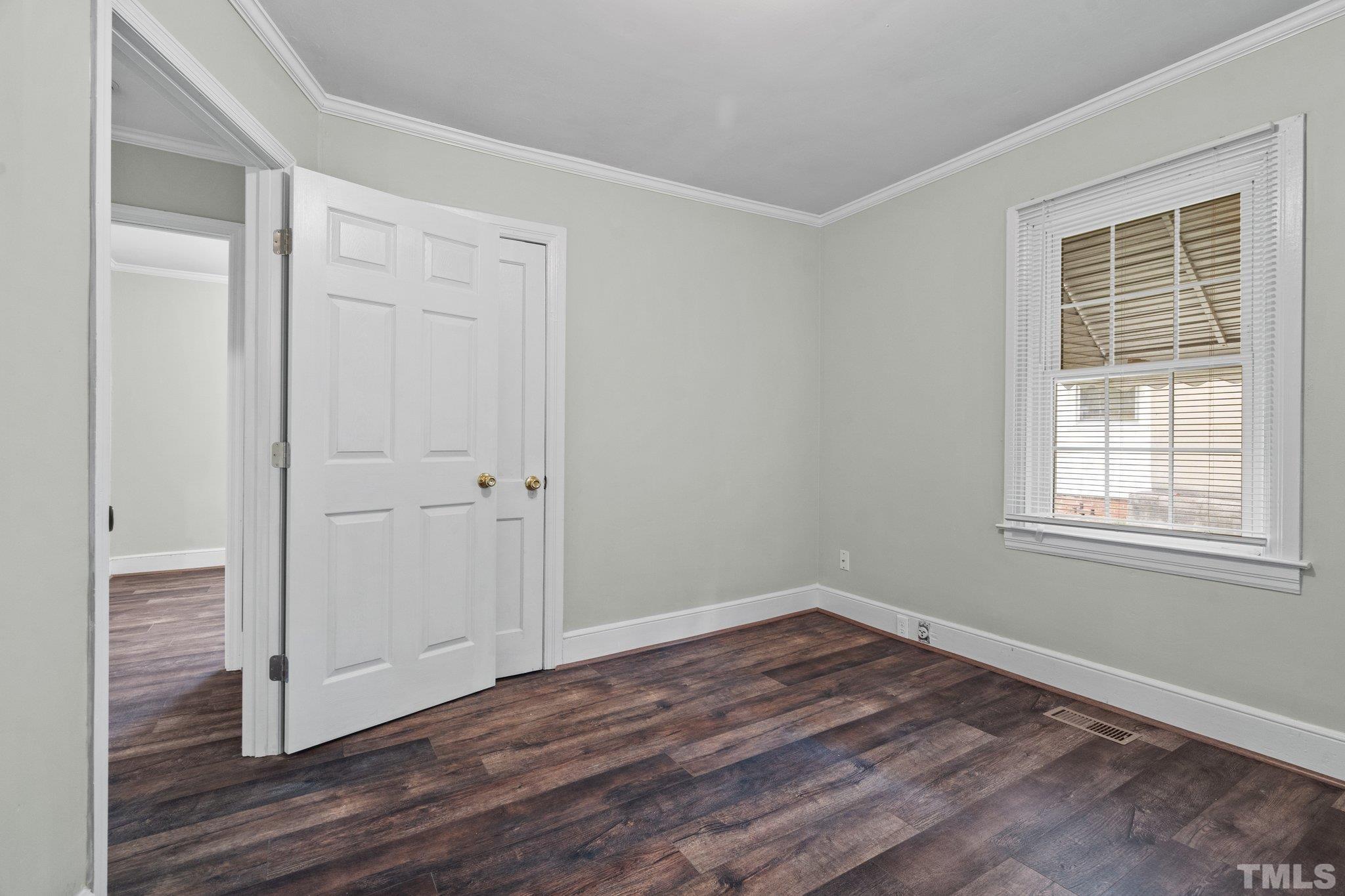203 Spring Street Louisburg, NC 27549 - Photo 9 of 23 a view of a room with wooden floor and windows