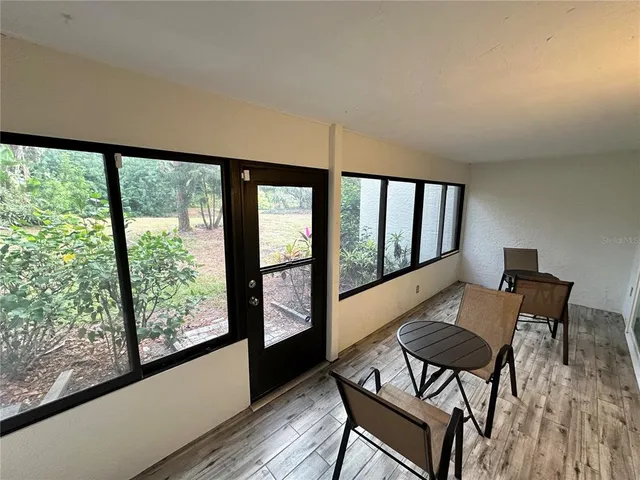 a view of a room with furniture and wooden floor