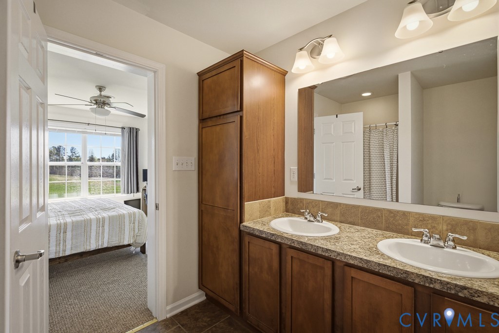 18262 Seals Road Bowling Green, VA 22427 - Photo 27 of 50 a en suite bathroom with a double vanity sink and a mirror