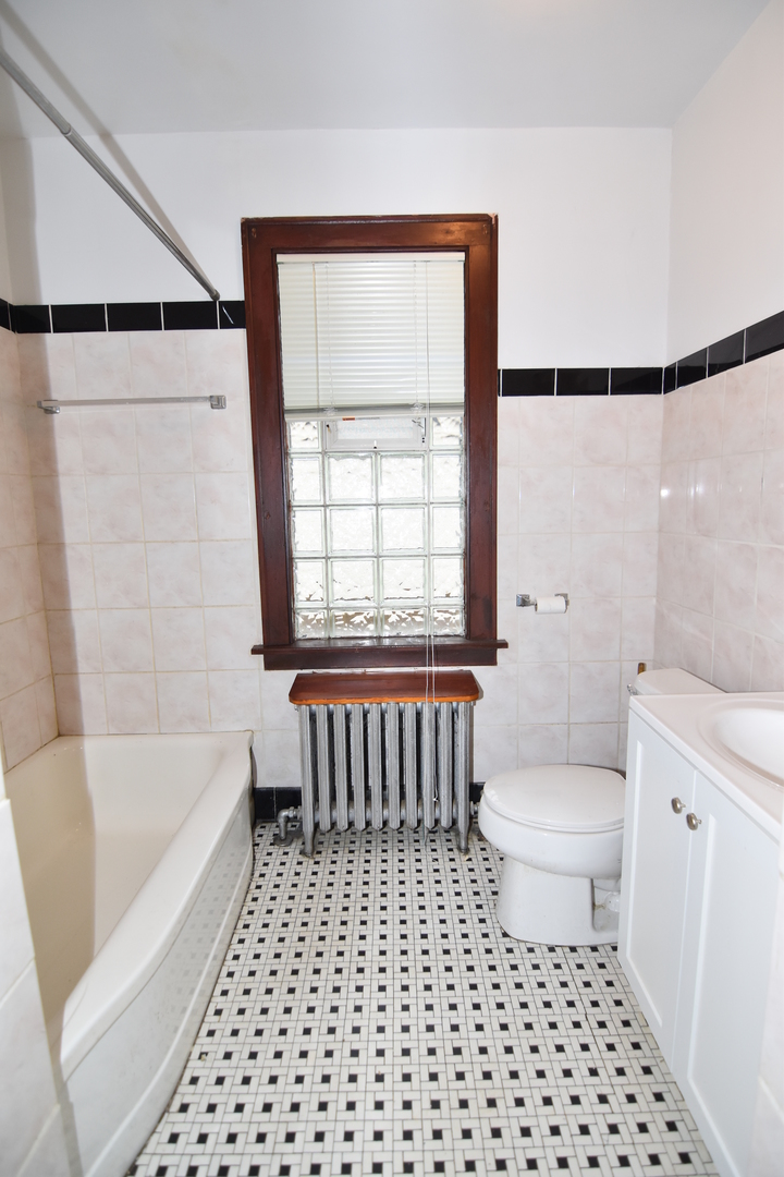 141 West 124th Street Chicago, IL 60628 - Photo 12 of 26 a bathroom with a toilet a sink and a bathtub