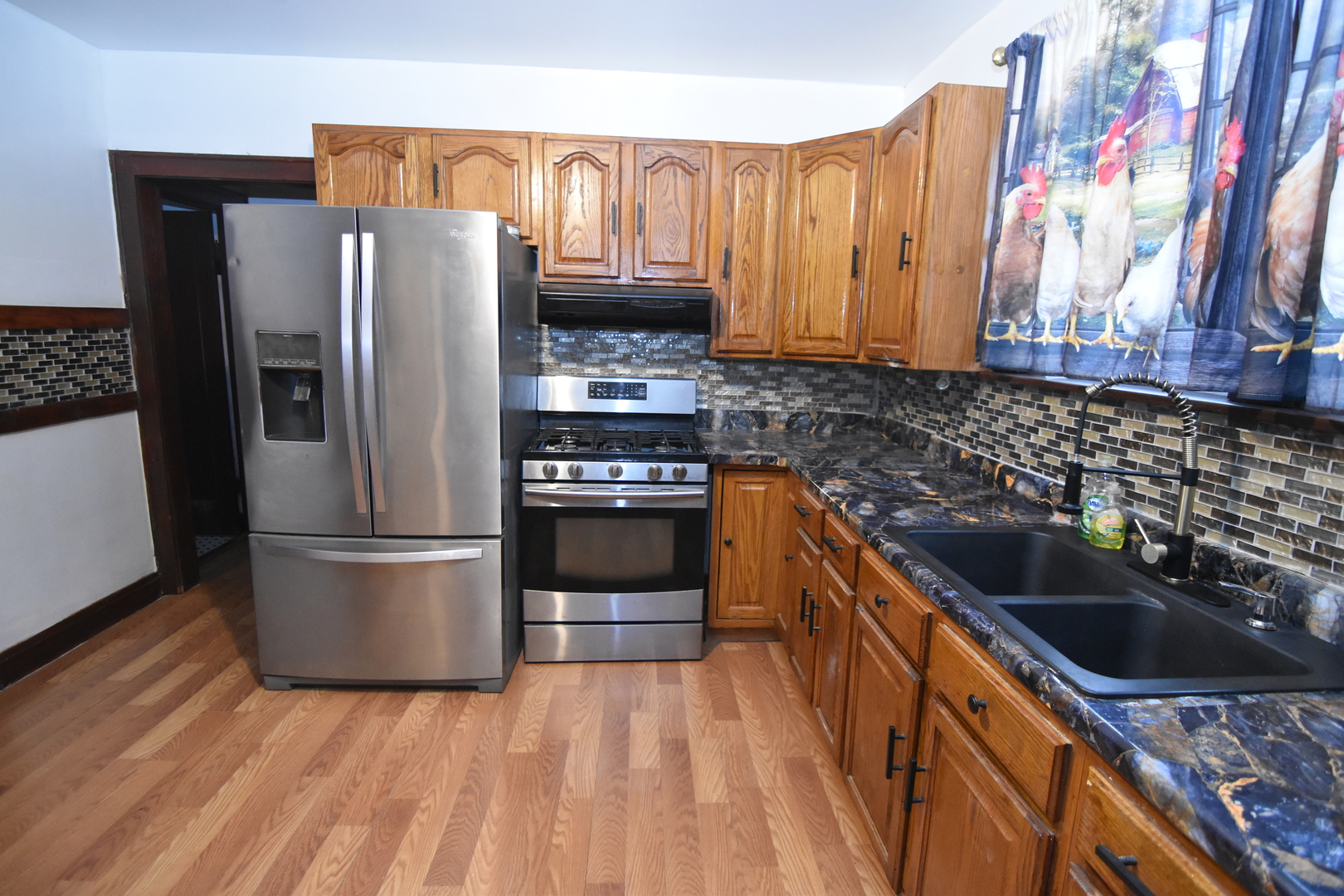 141 West 124th Street Chicago, IL 60628 - Photo 4 of 26 a kitchen with granite countertop a refrigerator stove and sink