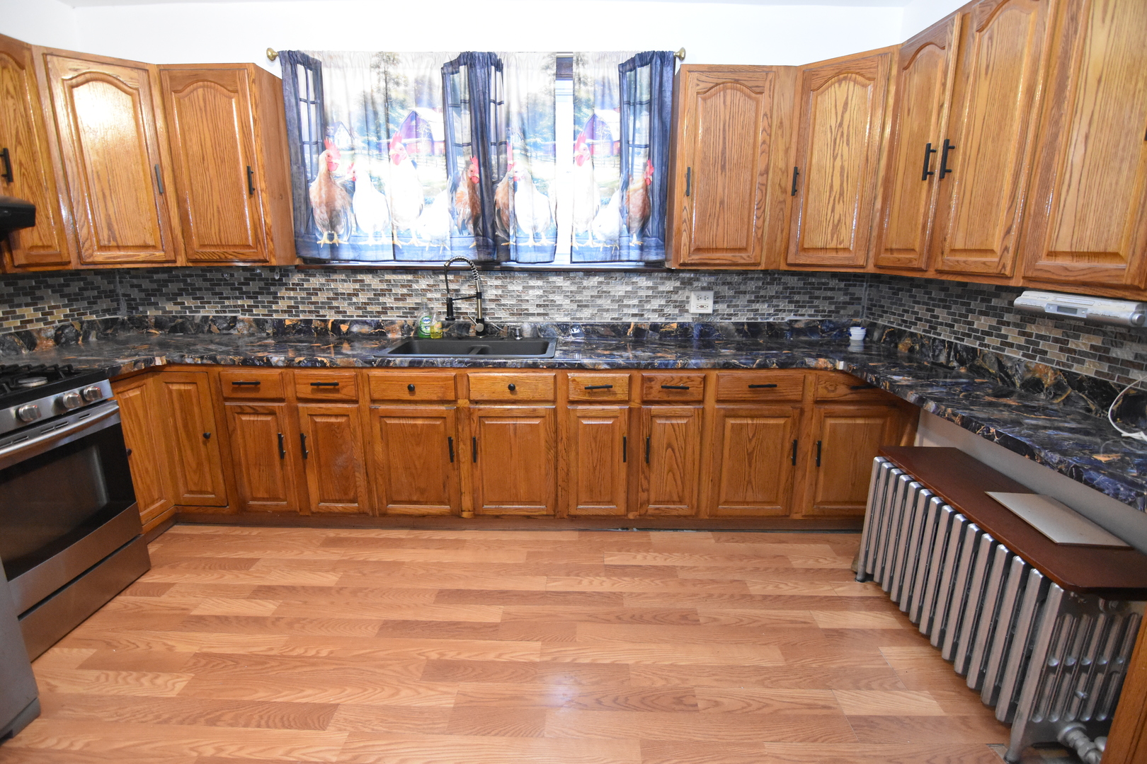 141 West 124th Street Chicago, IL 60628 - Photo 5 of 26 a view of a storage room cabinets and a wooden floor
