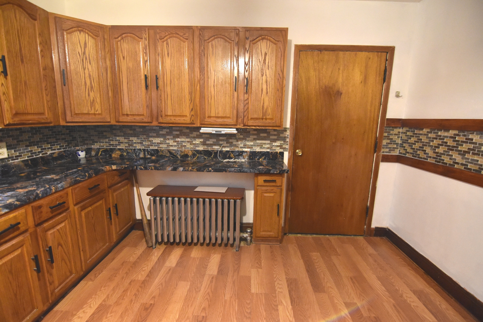 141 West 124th Street Chicago, IL 60628 - Photo 6 of 26 a view of a kitchen with wooden floor