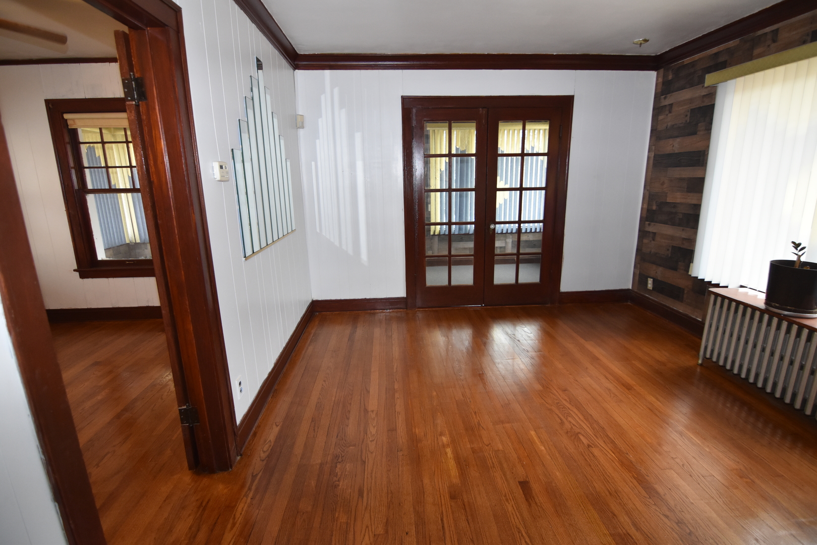 141 West 124th Street Chicago, IL 60628 - Photo 7 of 26 wooden floor in an empty room with a window