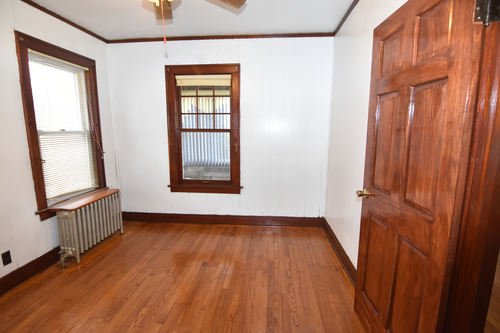 141 West 124th Street Chicago, IL 60628 - Photo 10 of 26 an empty room with wooden floor and windows