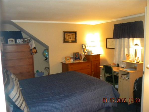 125 Newton Road Springfield, MA 01118 - Photo 19 of 24 a bedroom with a bed and a flat tv screen on the dresser