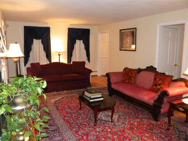 125 Newton Road Springfield, MA 01118 - Photo 3 of 24 a living room with furniture a bed and a lamp