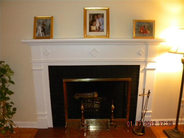 125 Newton Road Springfield, MA 01118 - Photo 4 of 24 a living room with a fireplace and a potted plant