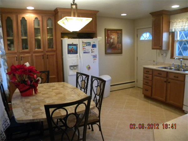 125 Newton Road Springfield, MA 01118 - Photo 8 of 24 a view of a dining room with furniture and chandelier