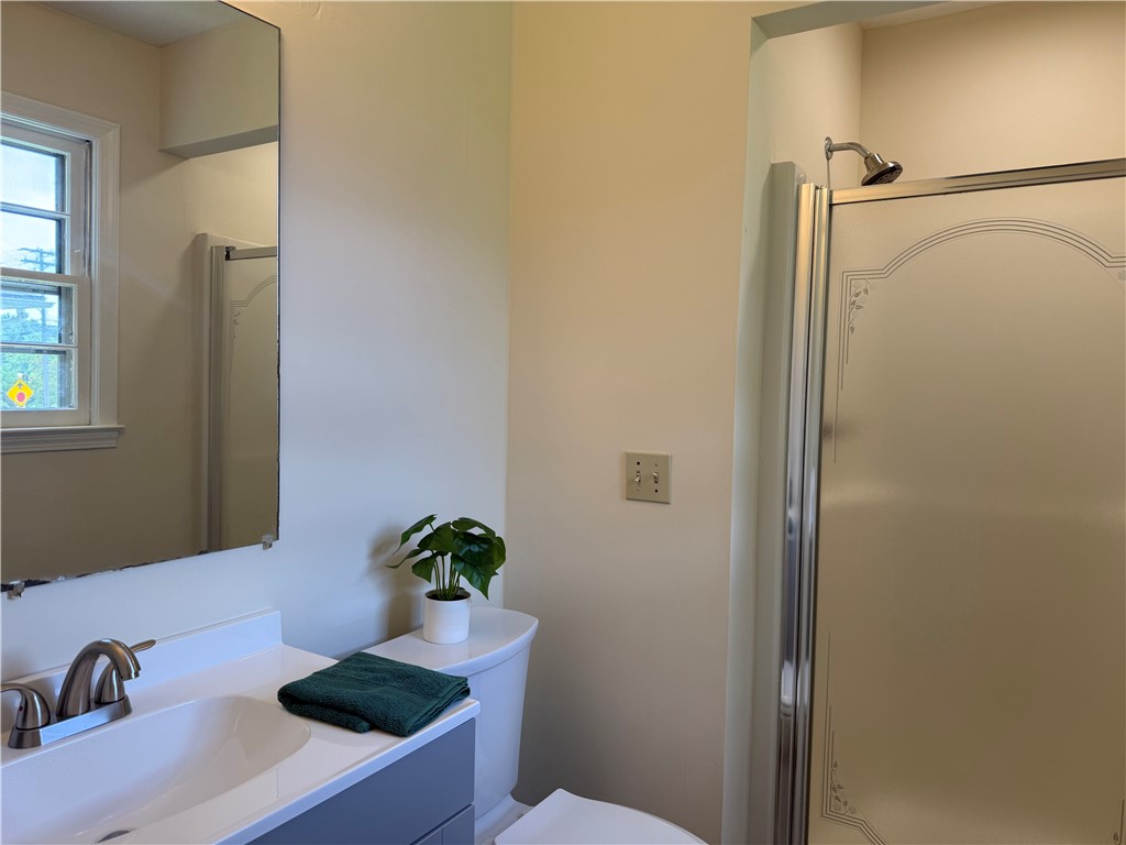 1507 East Calhoun Street Anderson, SC 29621 - Photo 14 of 18 A compact bathroom offers a functional vanity with an integrated sink and a convenient standing shower.