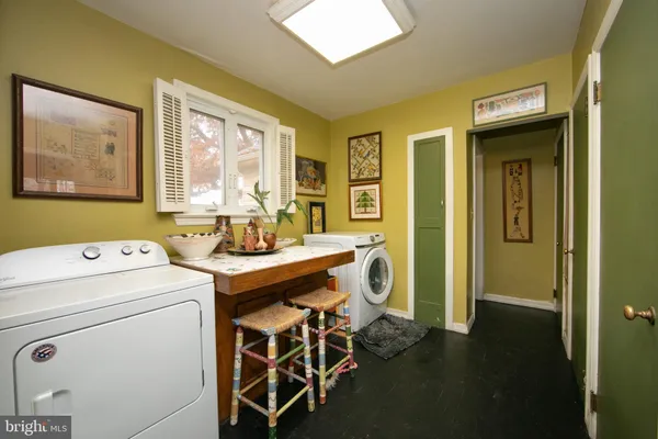 a bedroom with two beds and painting on the wall