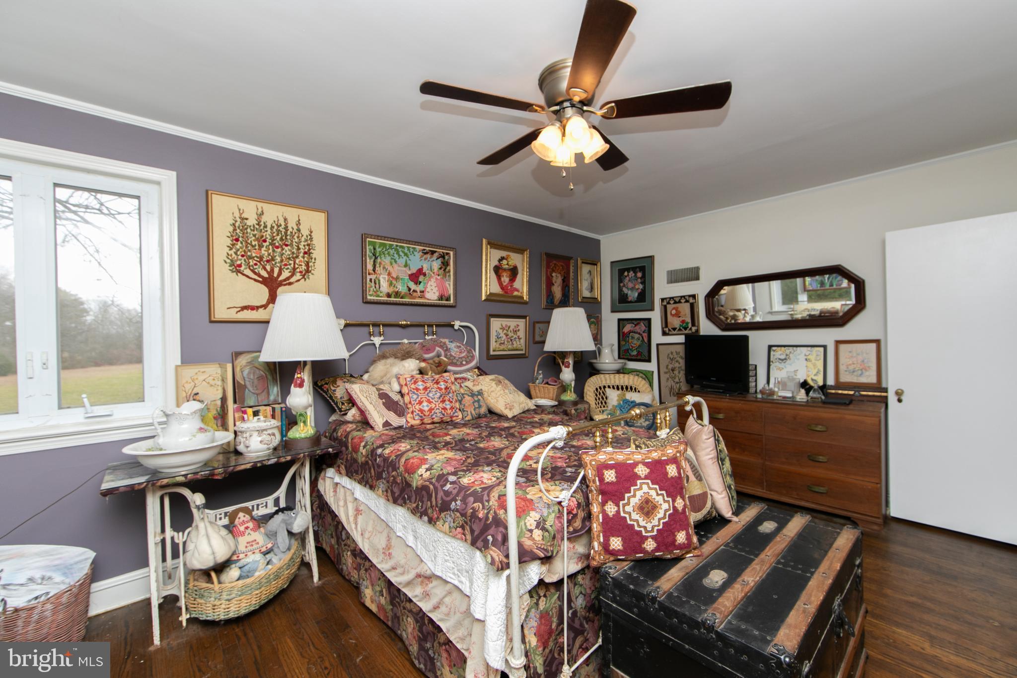 478 Highway 40 Elmer, NJ 08318 - Photo 38 of 65 a bedroom with a bed and a chandelier