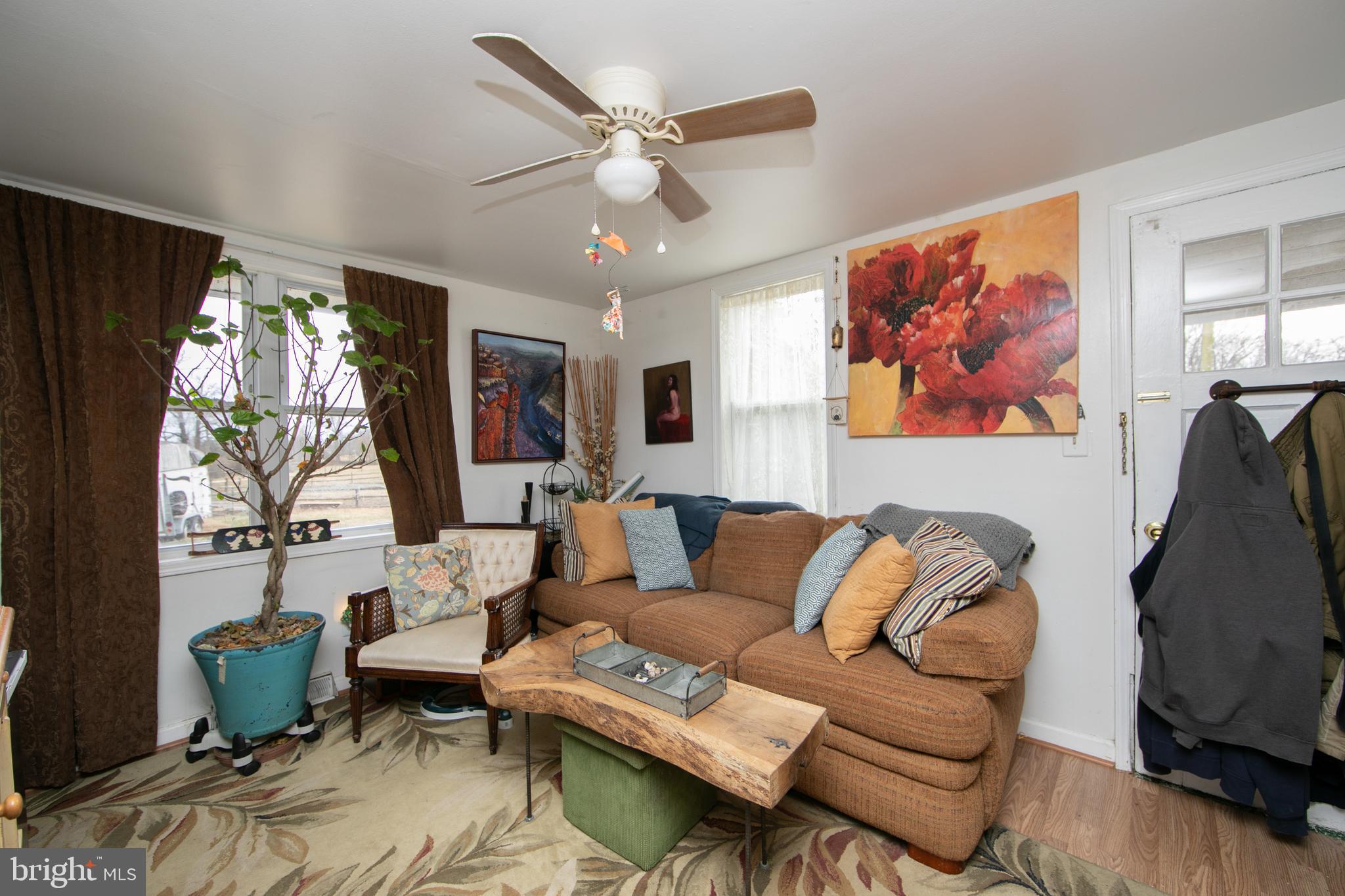 478 Highway 40 Elmer, NJ 08318 - Photo 46 of 65 a living room with furniture a flat screen tv and a window