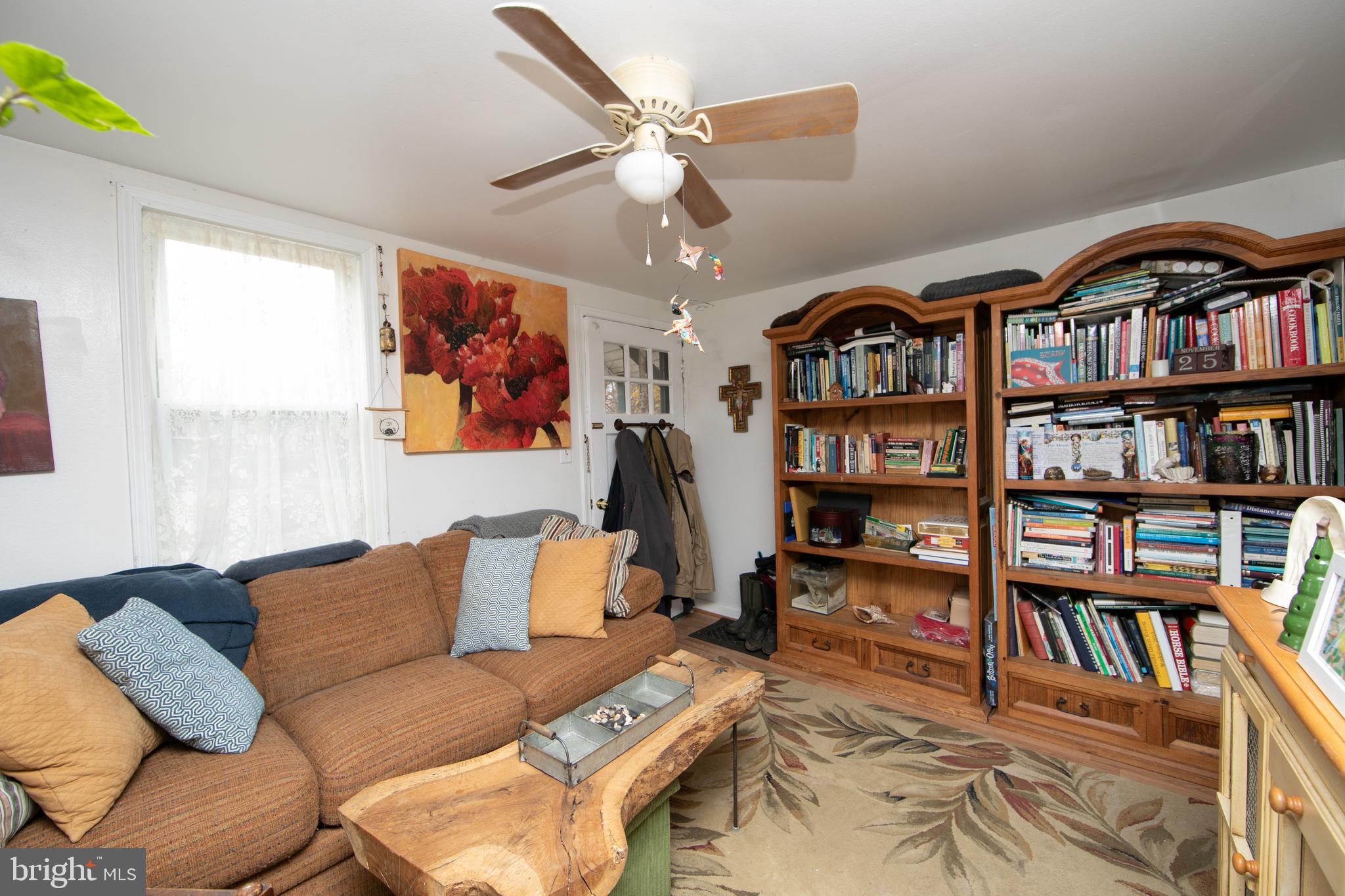 478 Highway 40 Elmer, NJ 08318 - Photo 47 of 65 a living room with furniture and a book shelf