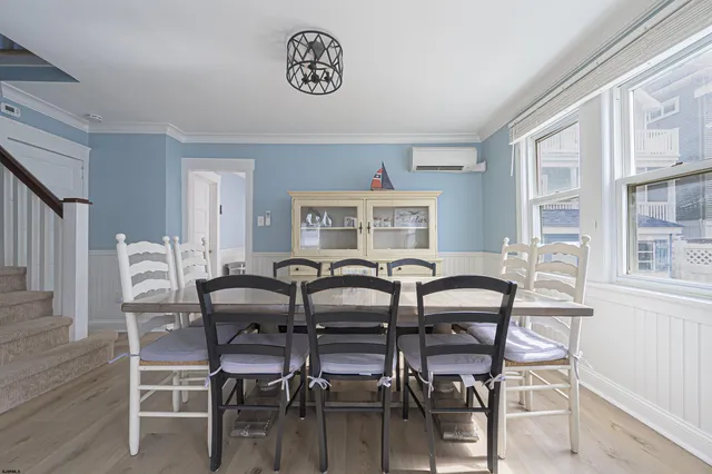 a view of a dining room with furniture and a window