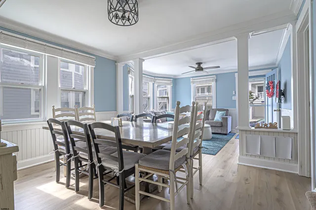 a view of a dining room with furniture and wooden floor