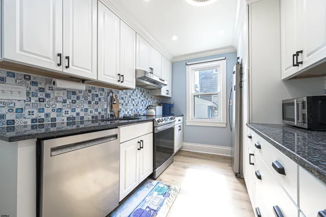 a kitchen with granite countertop a sink and cabinets